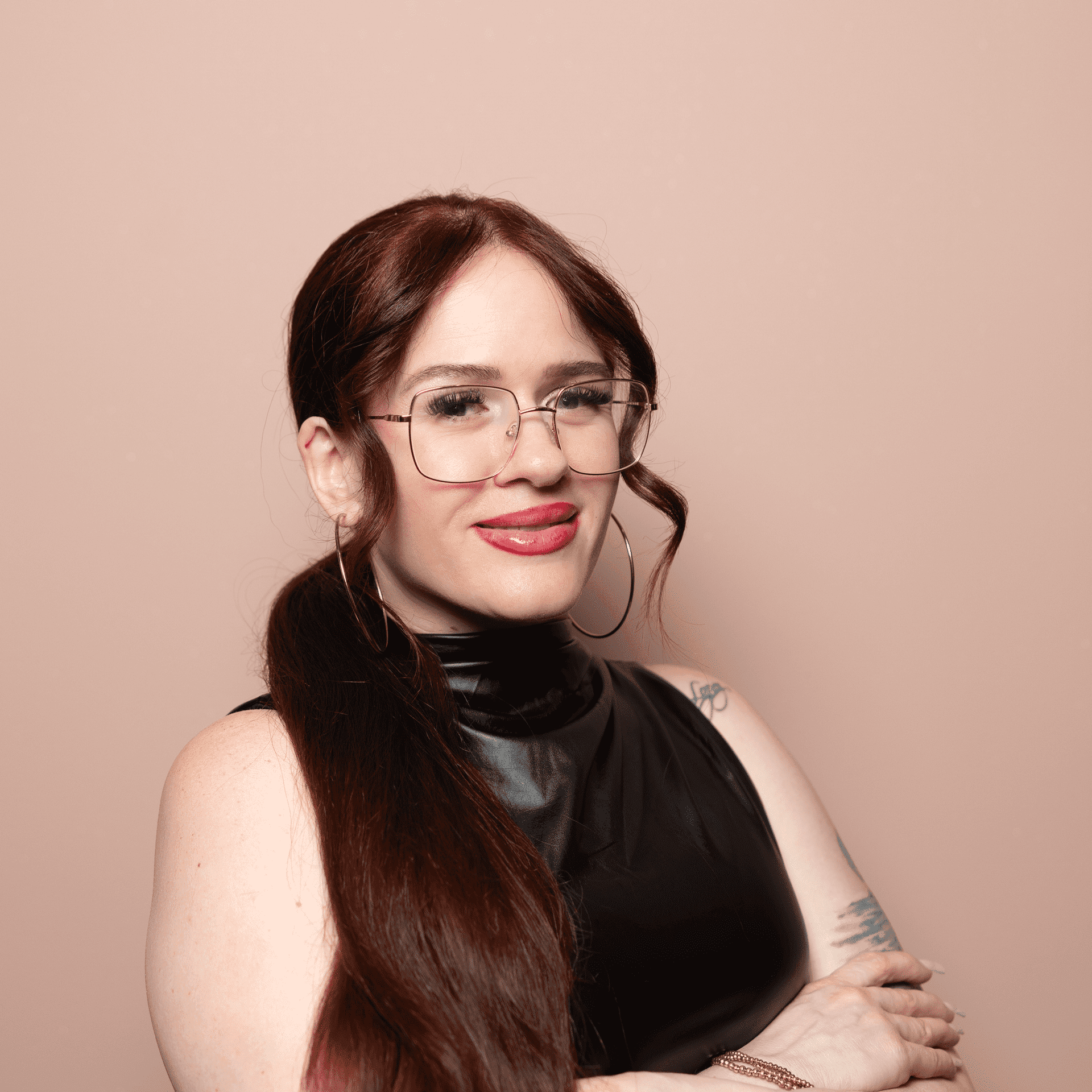 Portrait of Jomarie Rodriguez, a professional stylist at Buffalo Glam Salon, showcasing their expertise and style.