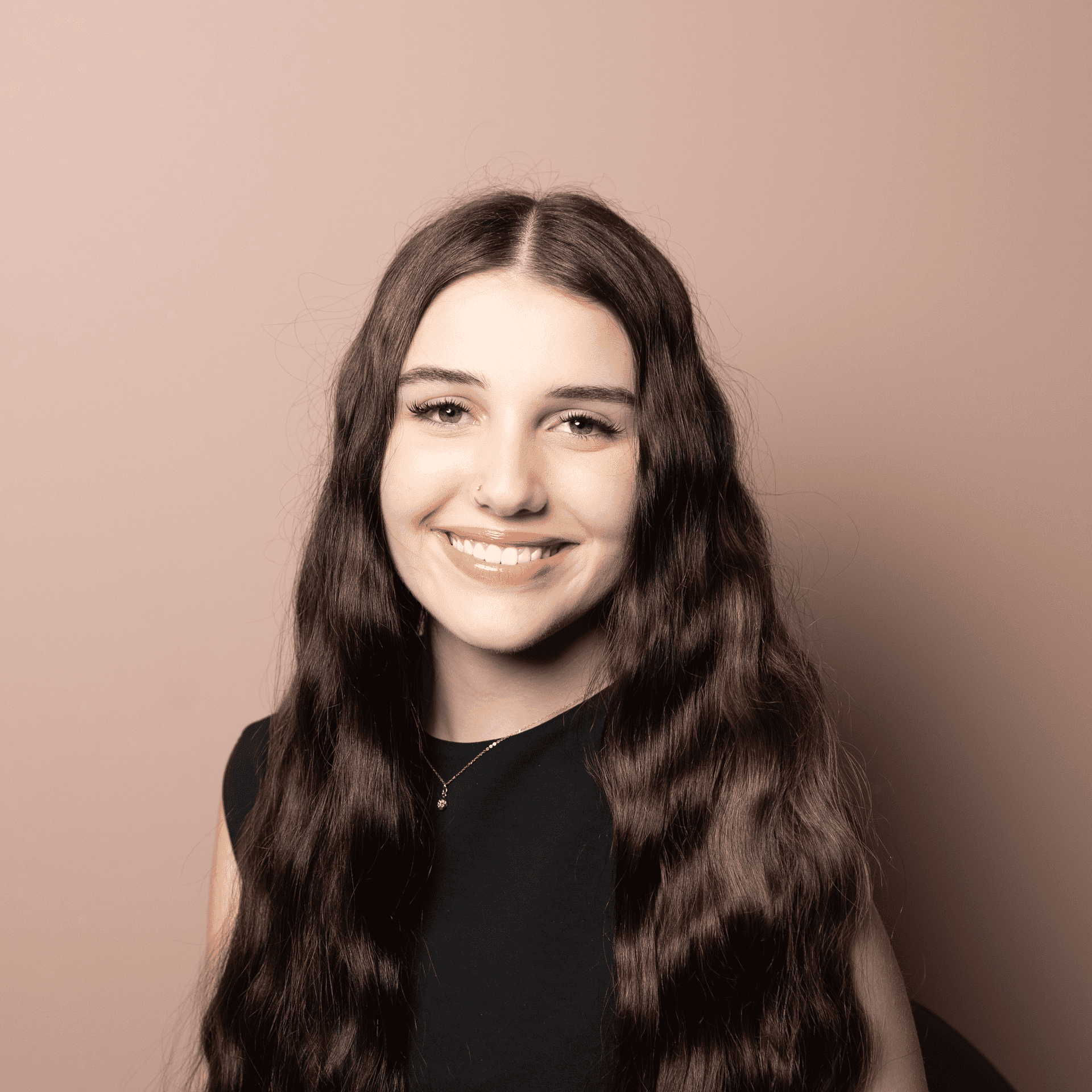 Portrait of Liberty, a professional stylist at Buffalo Glam Salon, showcasing their expertise and style.